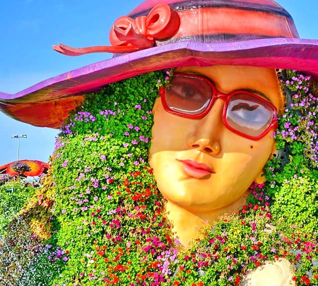 Flower Lady Sculpture is decorated with Petunia flowers.
