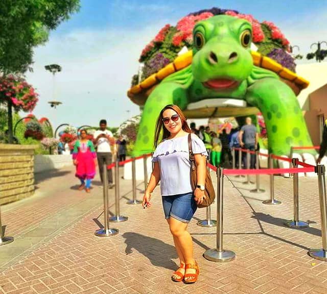 Visitors admire Giant Tortoise at the dubai Miracle Garden
